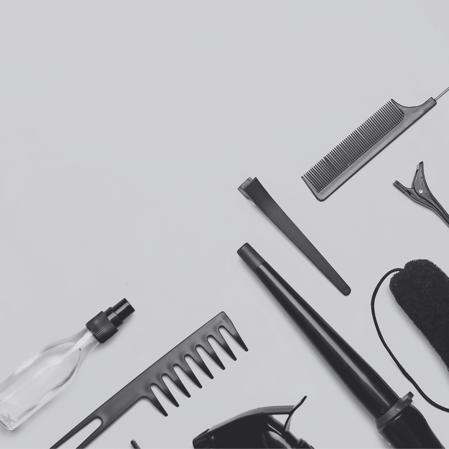 Hair styling tools and accessories arranged neatly on a light background.