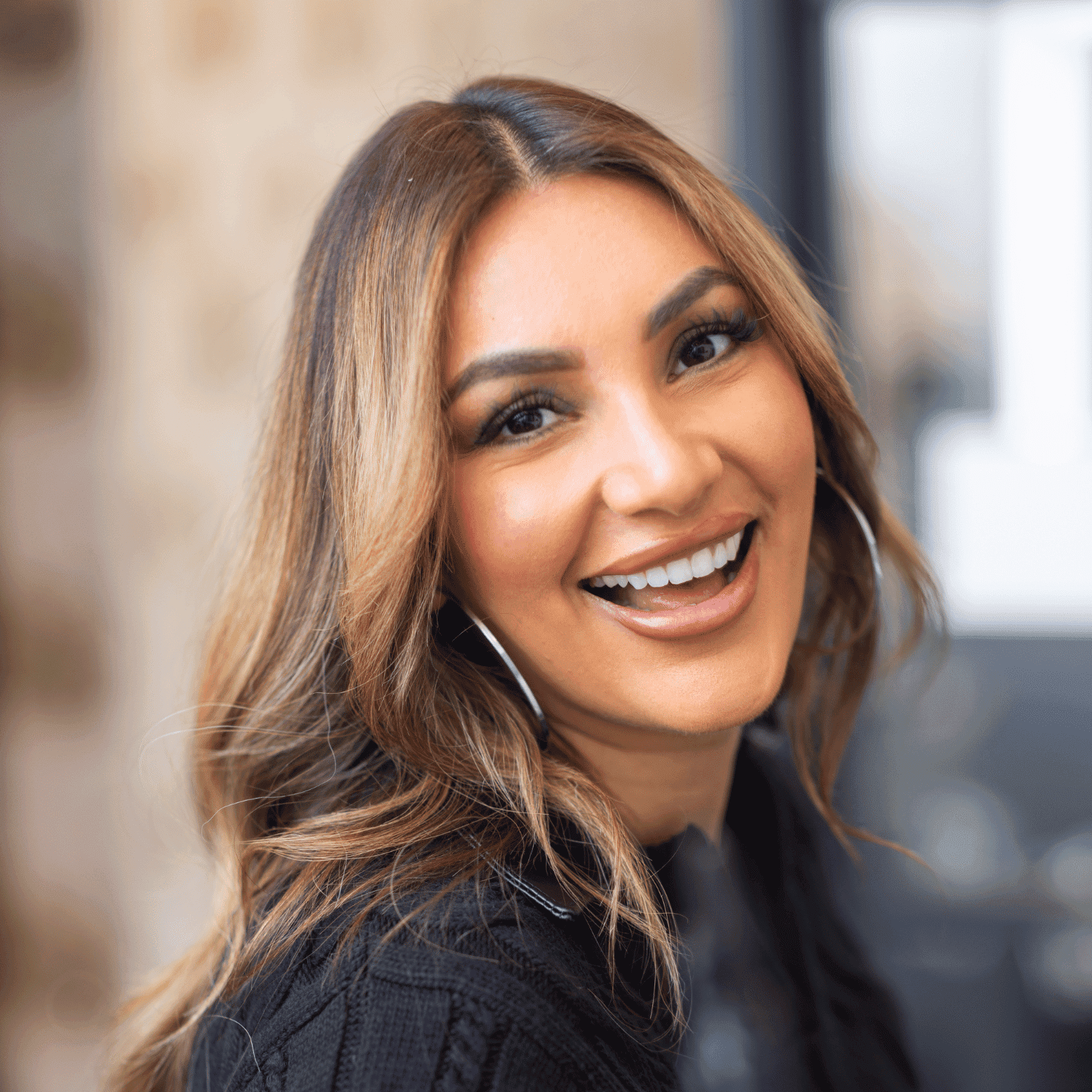 Portrait of Nilza Villanueva, a professional stylist at Revel Salon, showcasing their expertise and style.