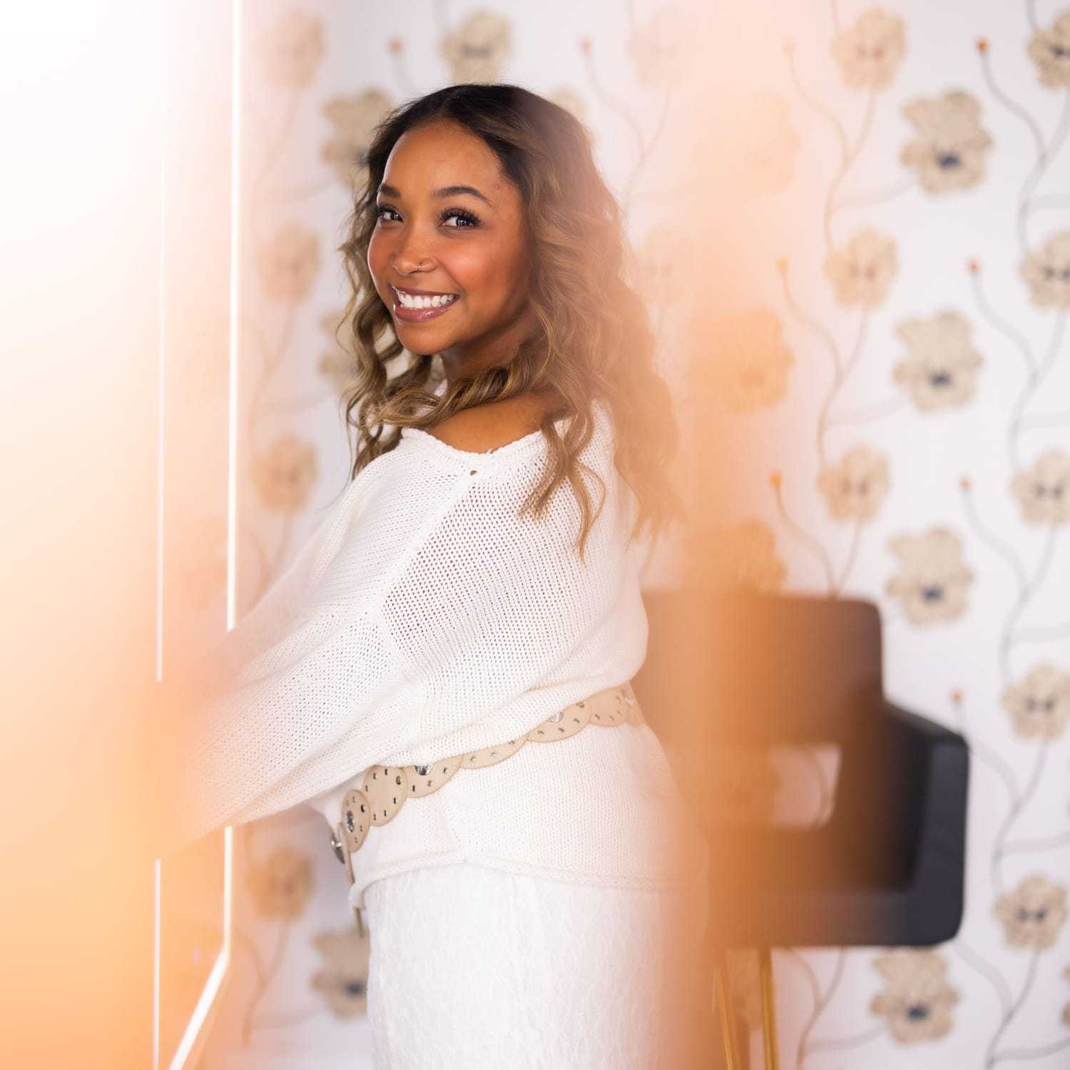Portrait of Kiara Inez, a professional stylist at Revel Salon, showcasing their expertise and style.